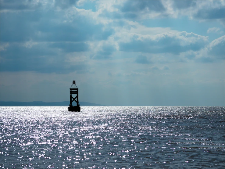 a large body of water with a tower sticking out of the middle