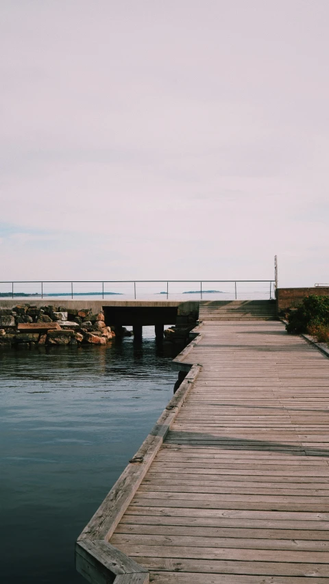 the long dock extends off into a body of water