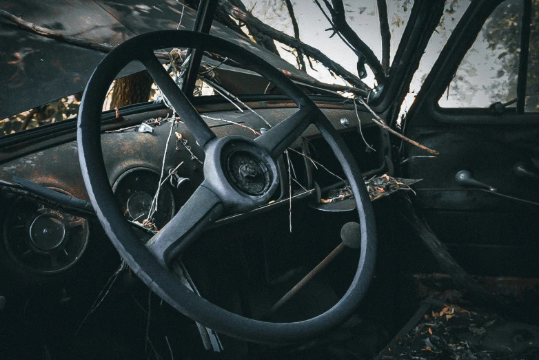 the steering wheel and dashboard of an old car