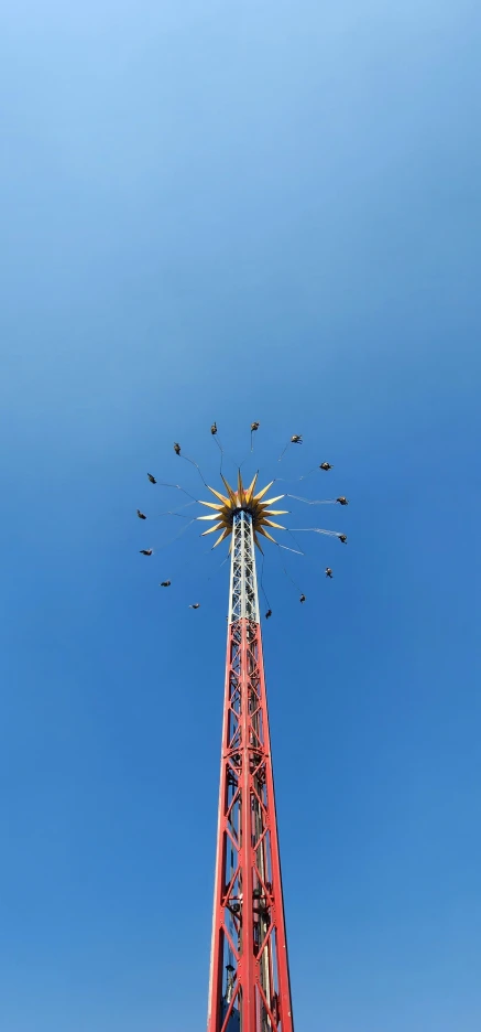 the large tower has birds on the top