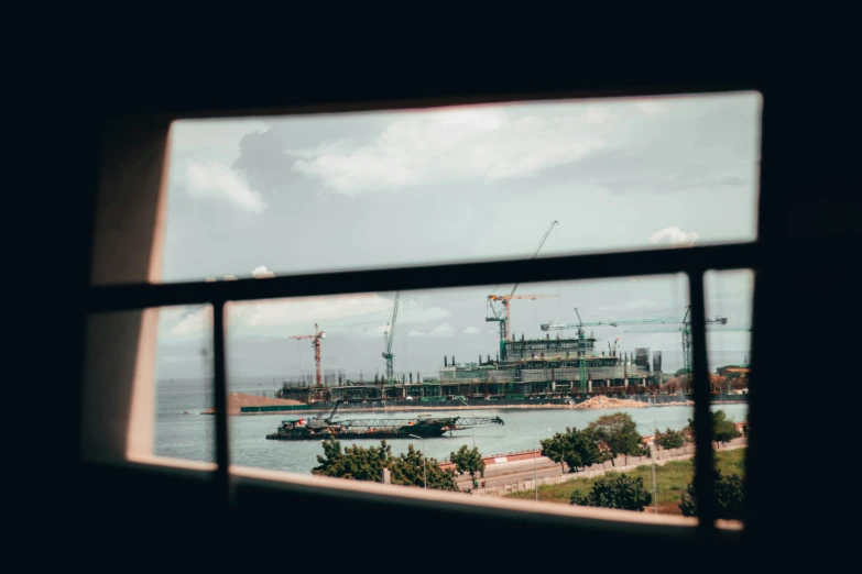 the view out of a window to a construction site