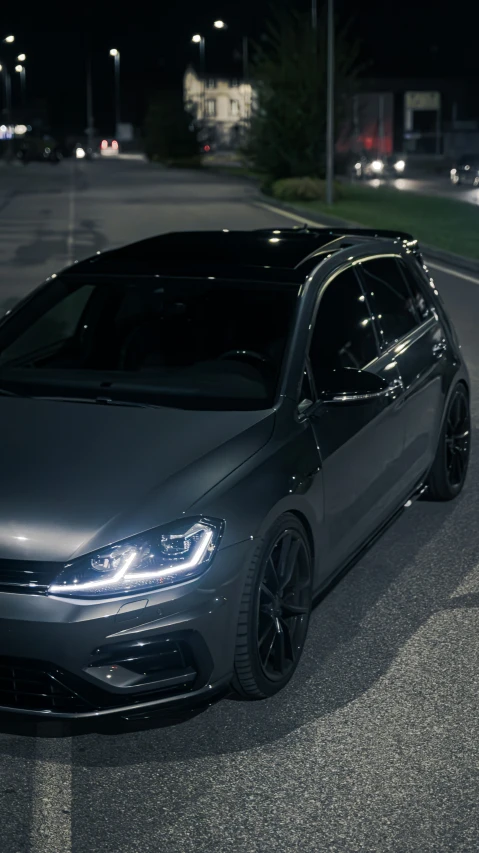 a black car parked in a parking lot at night