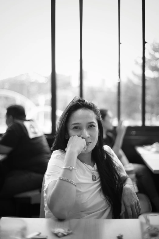 a woman sits at a table and eats