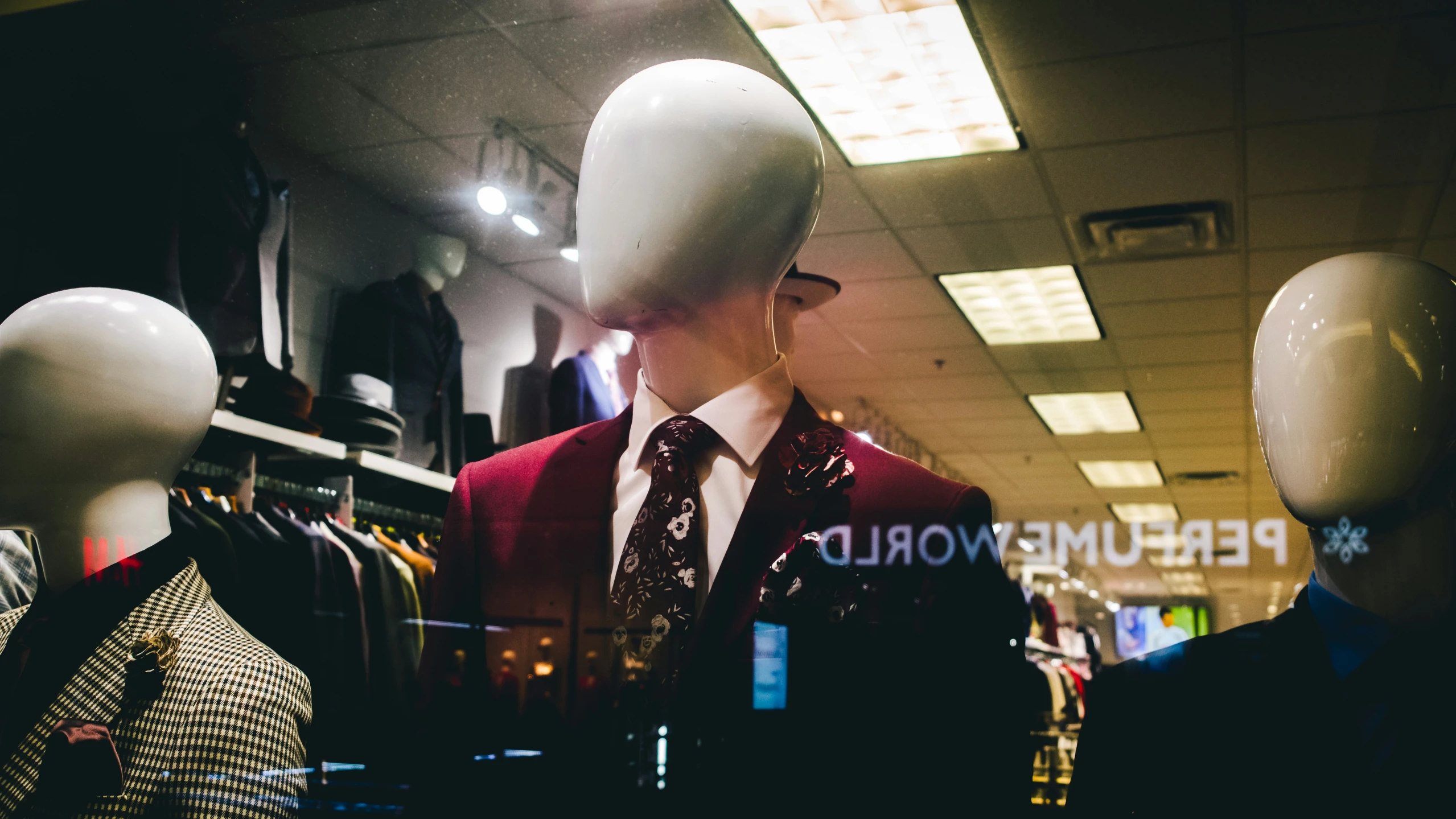 a display of suits, hats, and ties at the perplex world mall