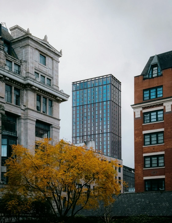 two large buildings in the city one has a clock on it