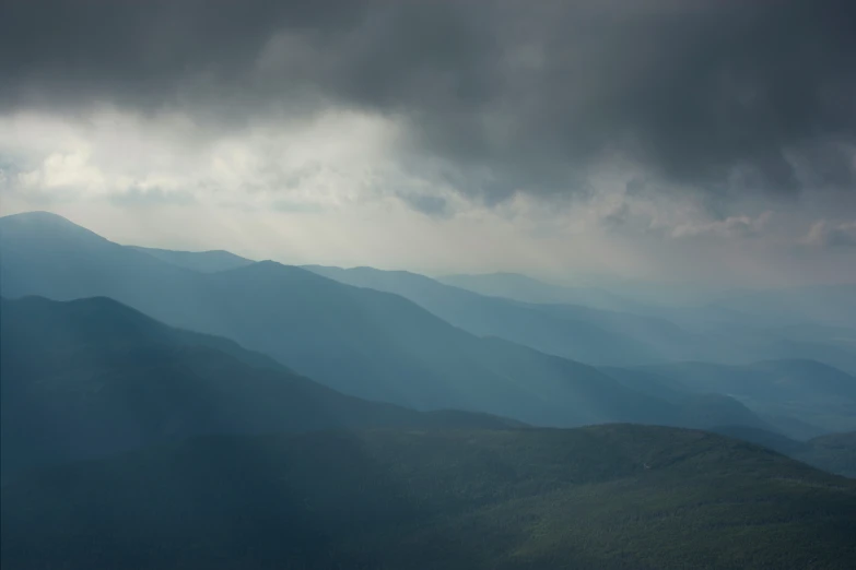 the mountains are very cloudy and can be seen in the distance