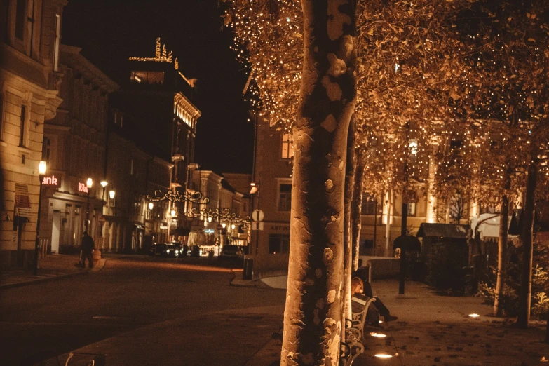 a couple sitting next to each other in the street at night