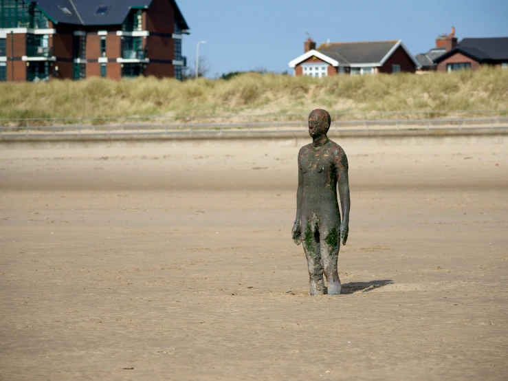 a boy made out of plastic on a beach