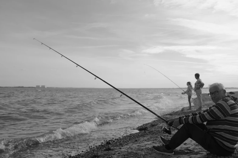 the man has two rods and a pole while fishing