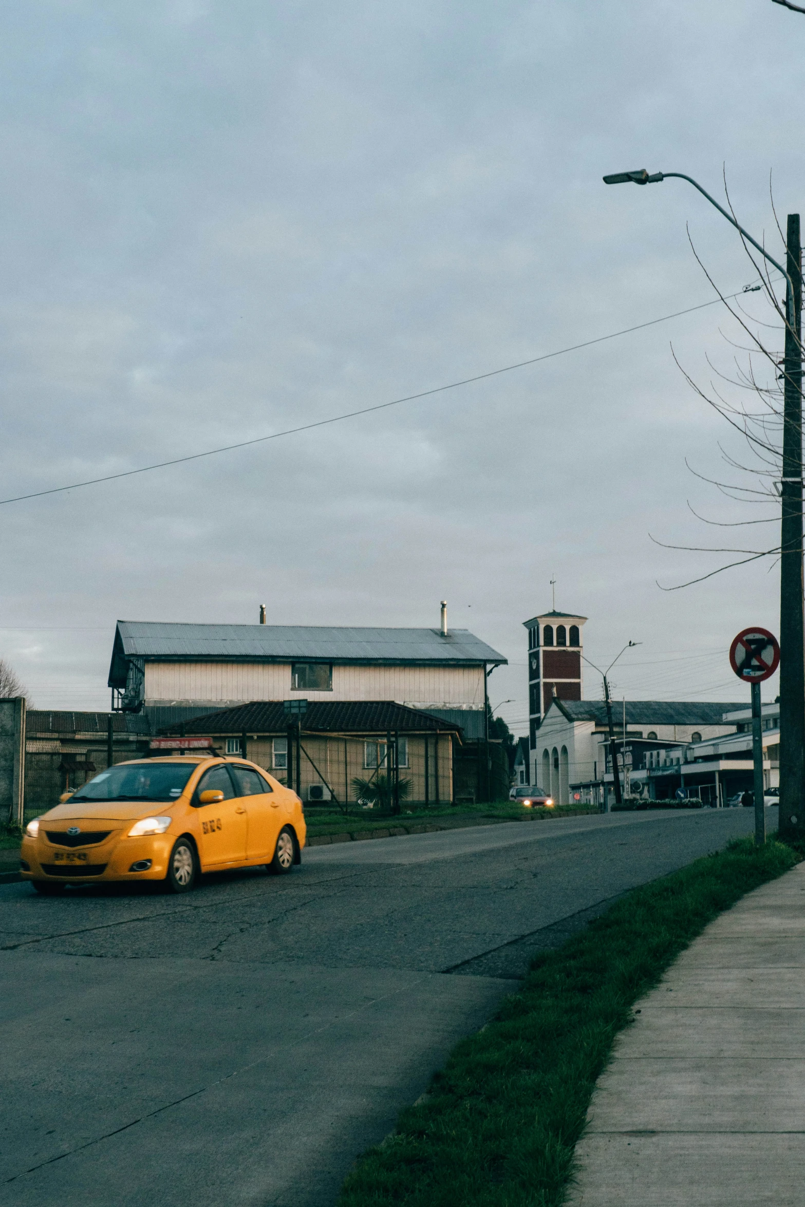 a yellow taxi cab driving down a street