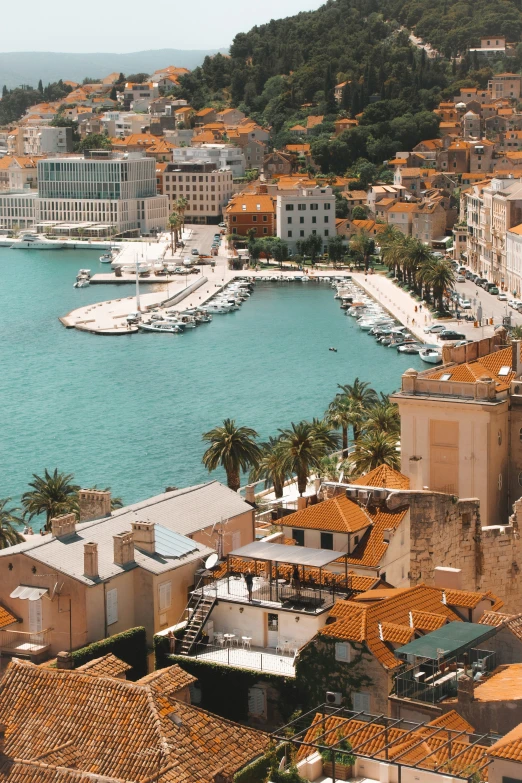 the view from a high building in a city with boats and homes