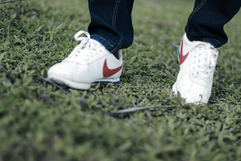 a pair of white and red tennis shoes