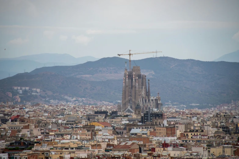 a view of barcelona, with the mountain behind