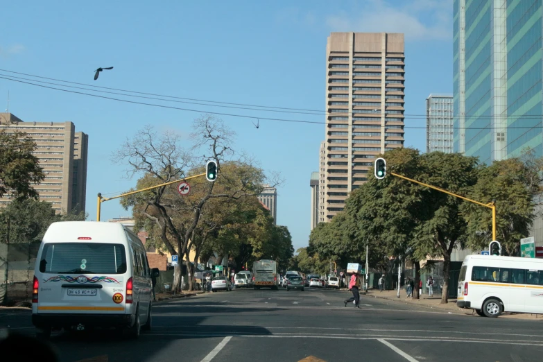 cars, buses and cyclists crossing in a street