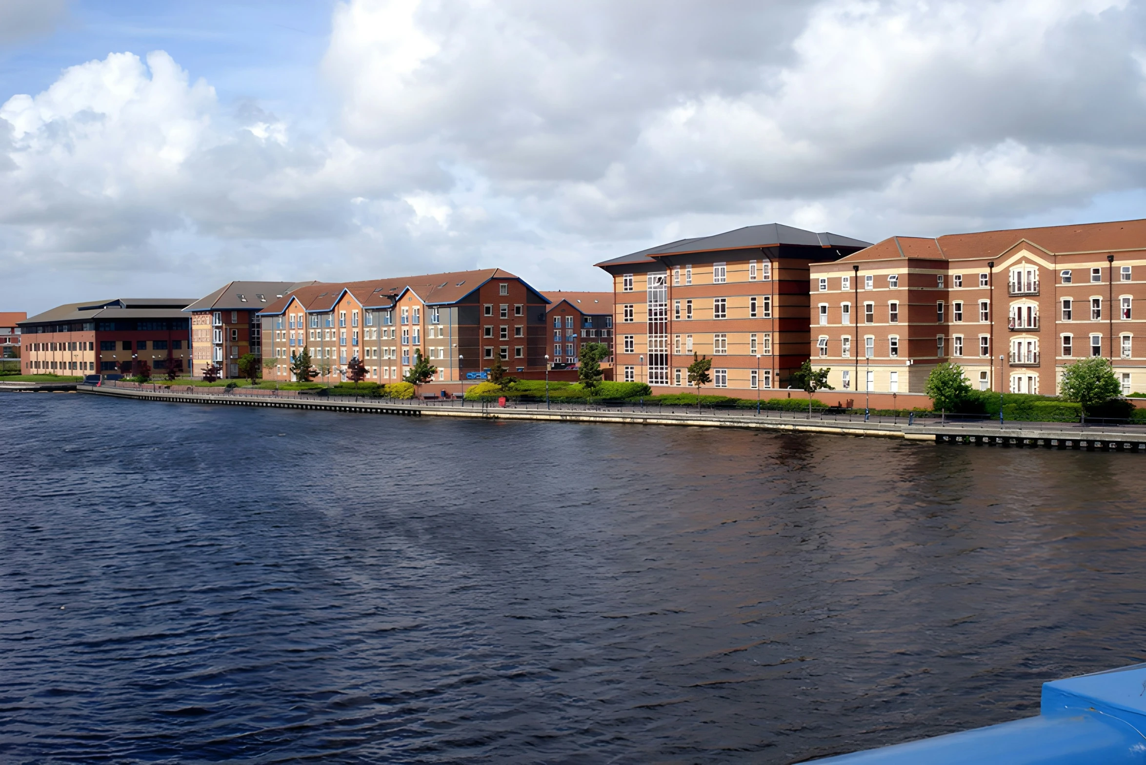 a bunch of buildings along the river with one boat