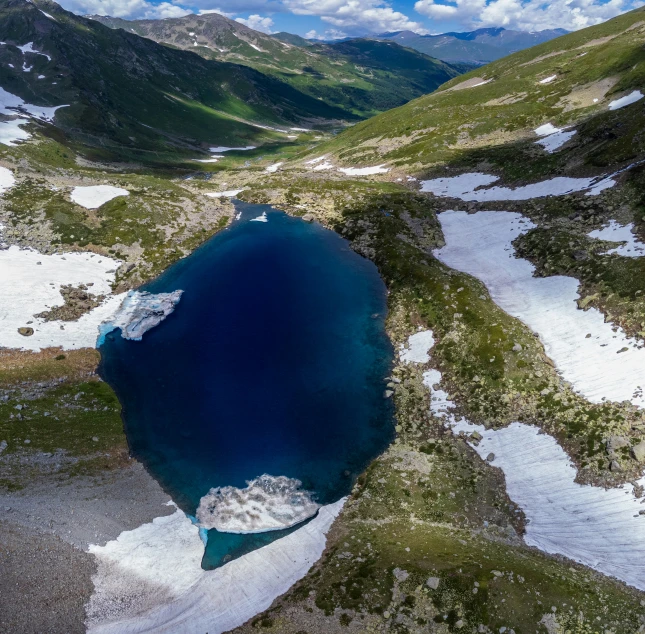 water is shown in a lake surrounded by mountains