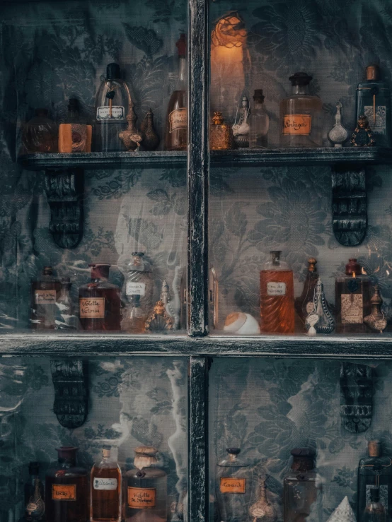 bottles of different kinds and shapes are displayed in a display case