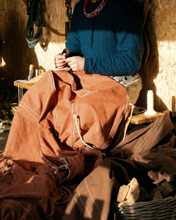 the woman is working on a bag in a stall