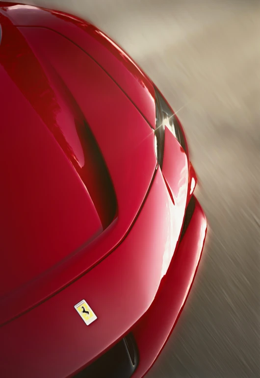 a red sports car on a road with trees in the background