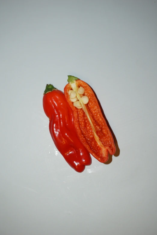 a piece of fruit with nuts and vegetables on a table