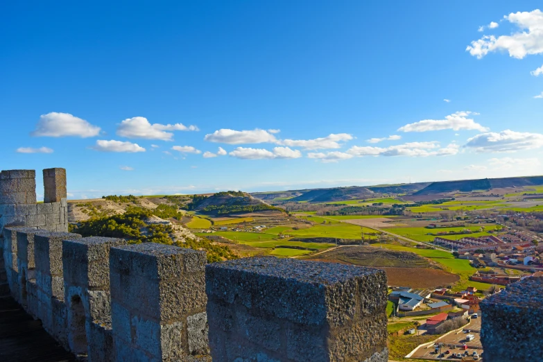 an old castle on a hill with a grassy field