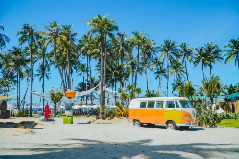 the van is parked on the beach by some trees