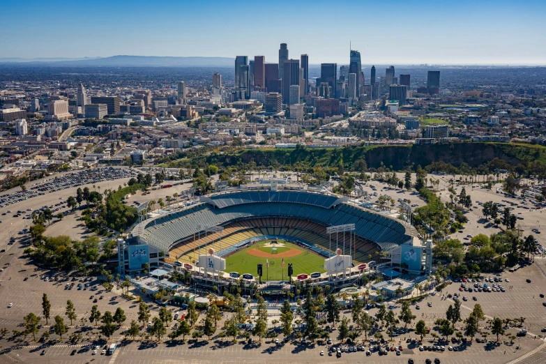 aerial view of a baseball stadium with lots of trees in the foreground