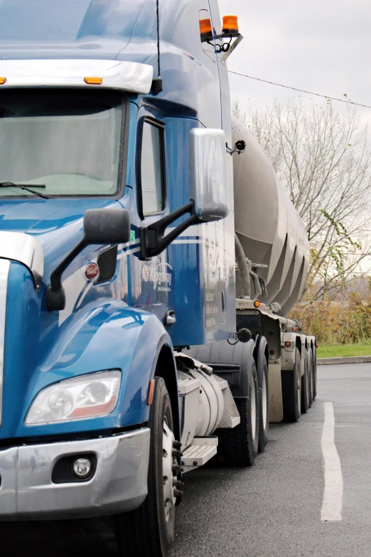 a truck on the road is blue with a silver engine