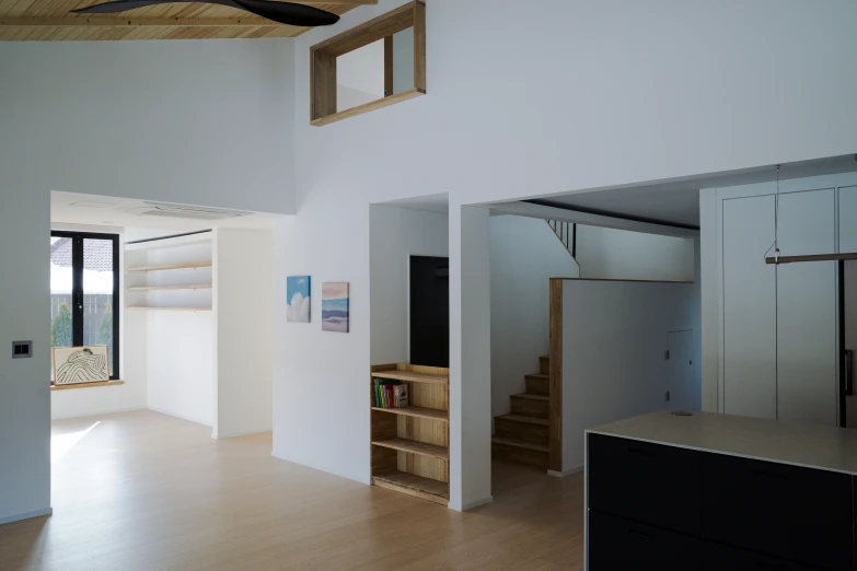 a living room that has an open door and an open shelf in the center