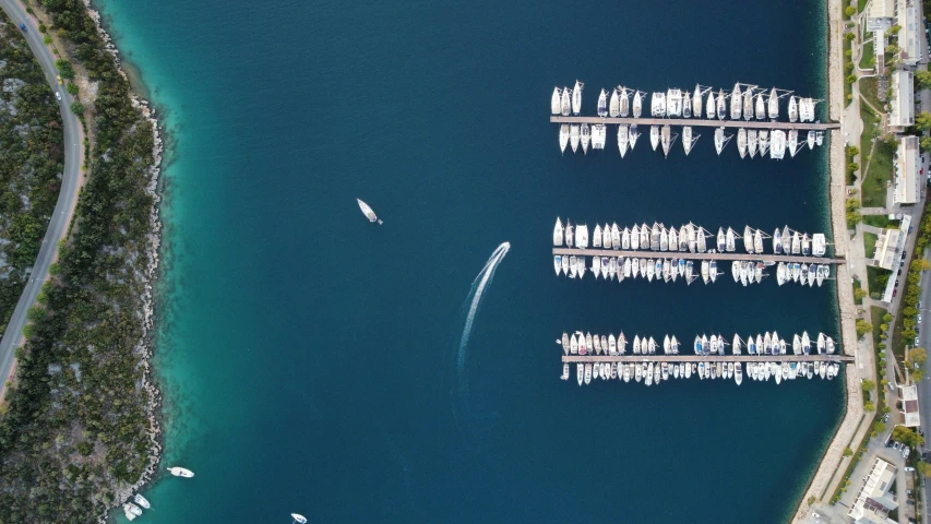 aerial view of boats and a city along side a body of water