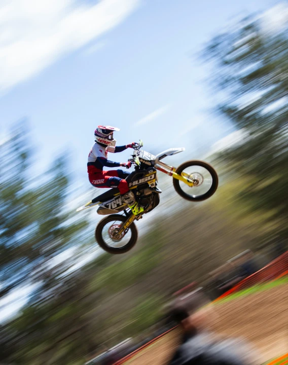 a motorcyclist flying through the air while riding in an empty course