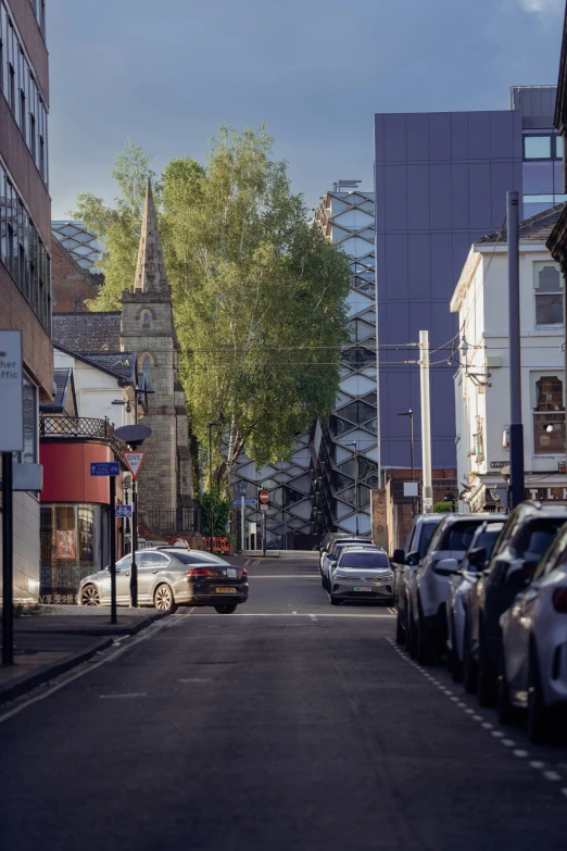 cars are parked on a city street with no one in it