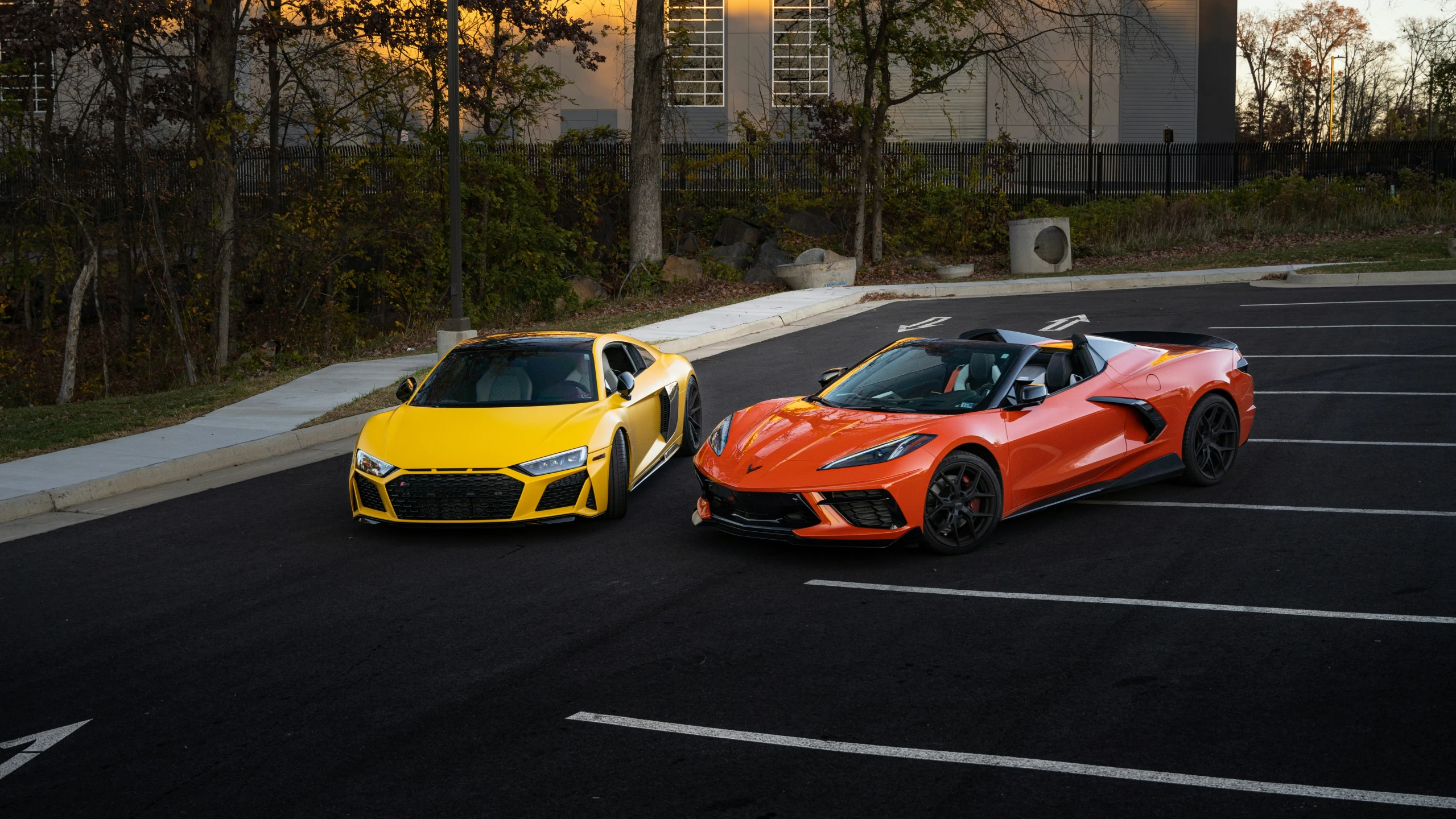 two new sports cars parked in a parking lot