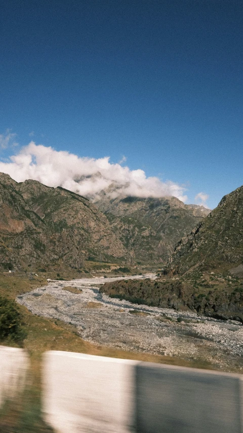 there is a view of a mountain valley from a train window