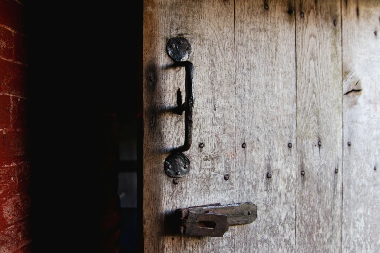 a door handle is seen on a wooden door