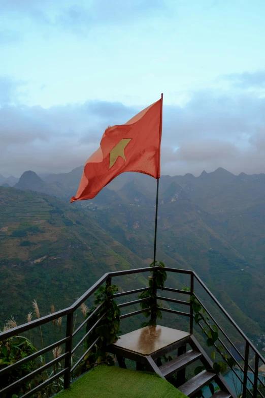 a flag waving on top of a wooden bench