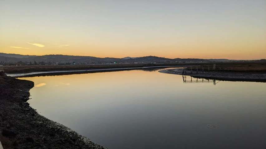 the water is calm and still calm for a couple of birds