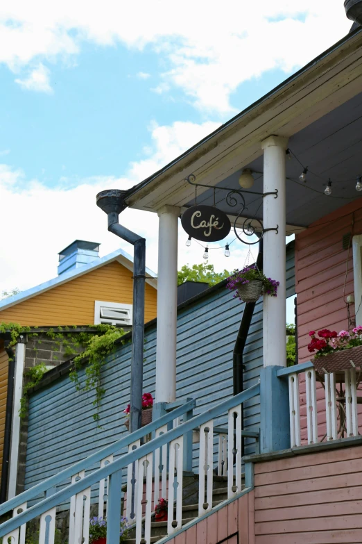 porch with various colored sidings and flowers