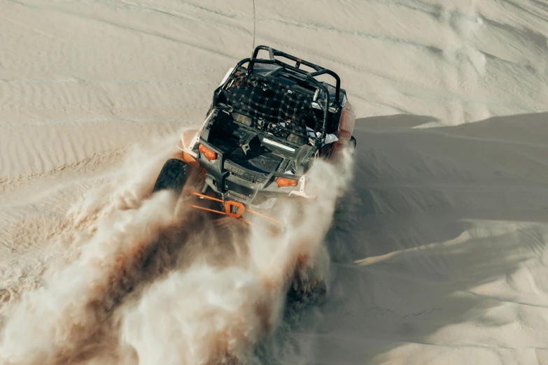 the front wheels of an atv drive through a desert