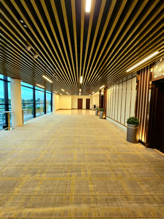 a view of a lobby area looking through the window to a city