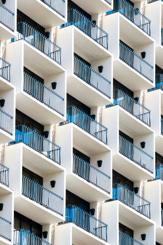 the balconies of an apartment building are white and blue