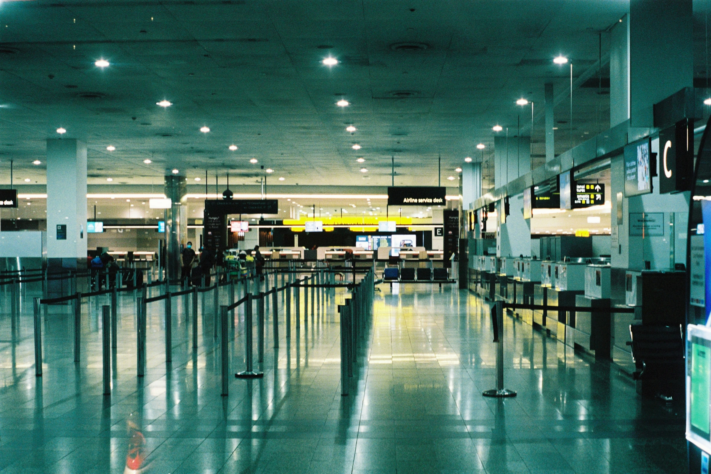 people walking through the inside of an airport