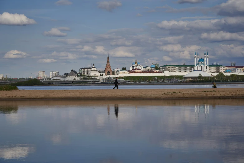 the people are walking on the beach in the sand