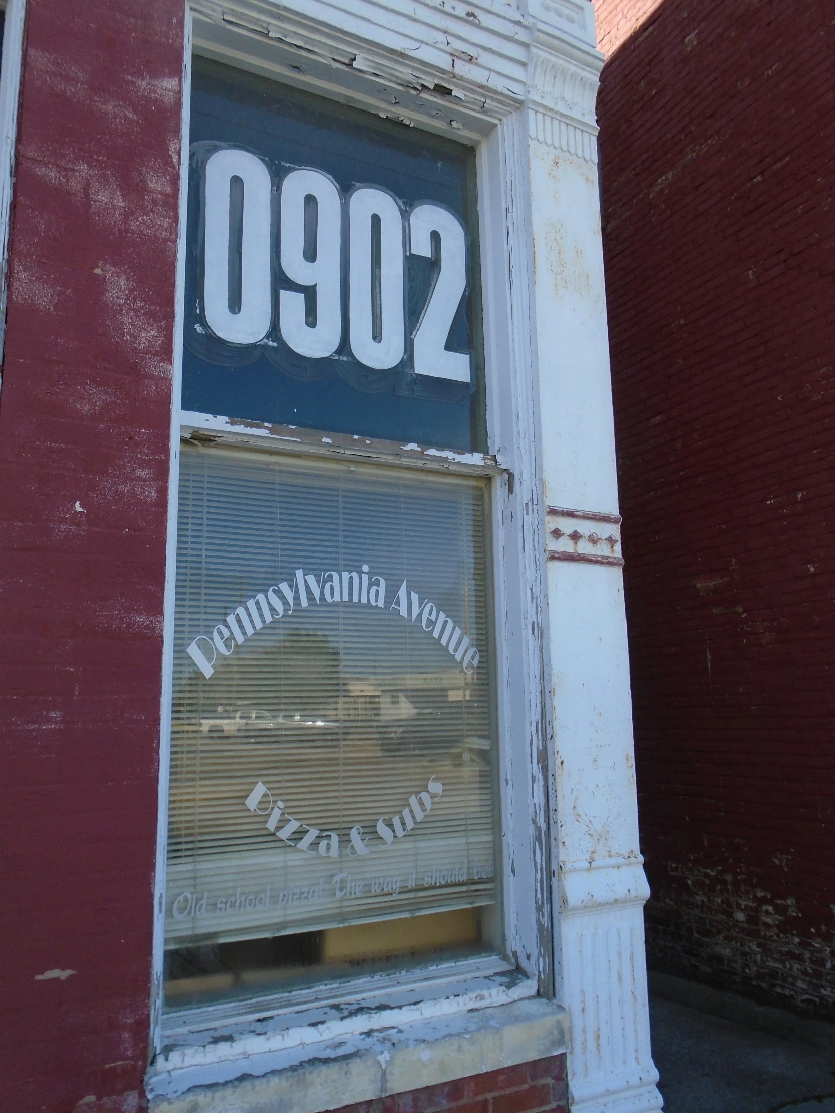 an old window with a sign that reads 0902 and the word, pennsylvania adams