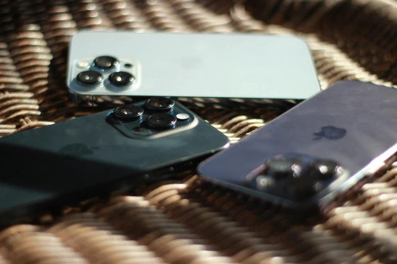 several electronics laying on top of a woven surface