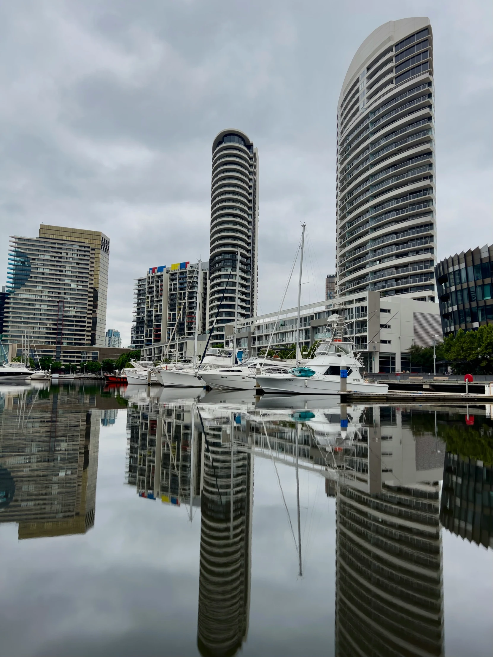 the buildings are very tall and there is still water in the lake