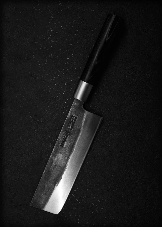 a small knife sitting on top of a black table