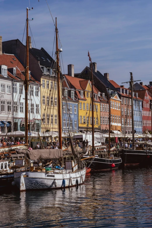 a group of boats floating next to each other near buildings