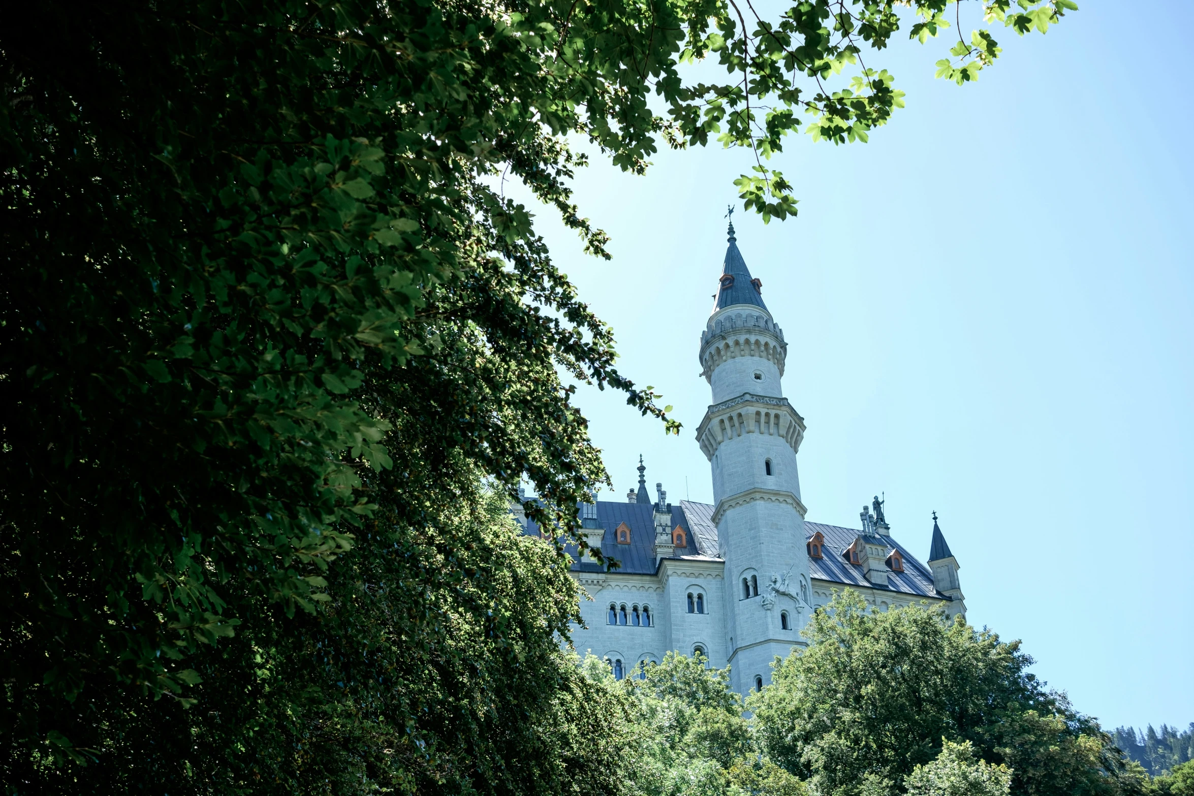 a large white and brown building with a spire