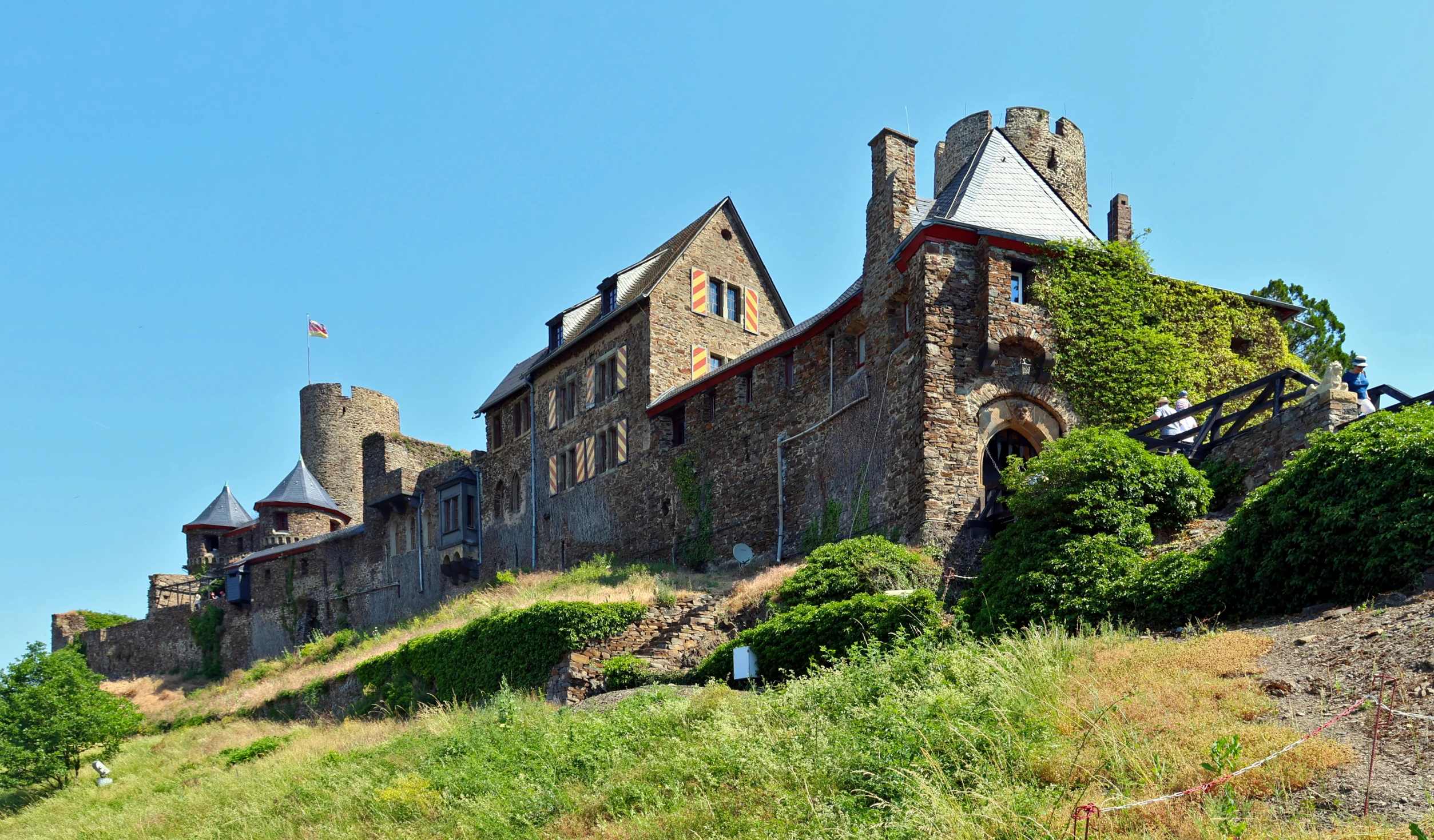 a castle on top of a hill in the blue sky